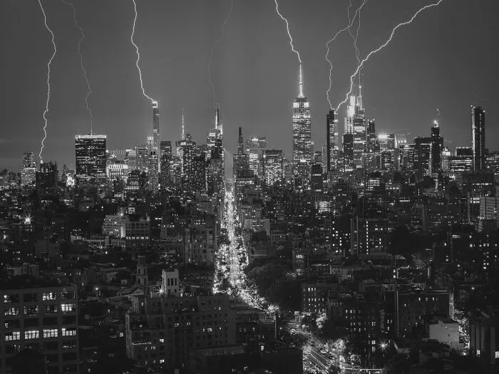 Striking black-and-white photo capturing lightning over a city skyline from Exposure One Awards.