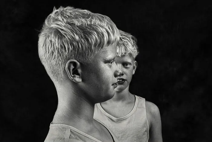 Black-and-white photo of two young boys in profile from the Exposure One Awards