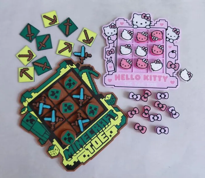Two 3D prints of custom Minecraft and Hello Kitty themed tic-tac-toe board games