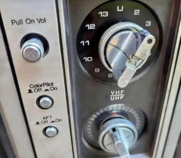 Vintage TV tuner dial with VHF and UHF settings and knobs