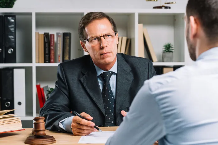 A lawyer discussing legal proceedings with a client regarding real-life divorce stories