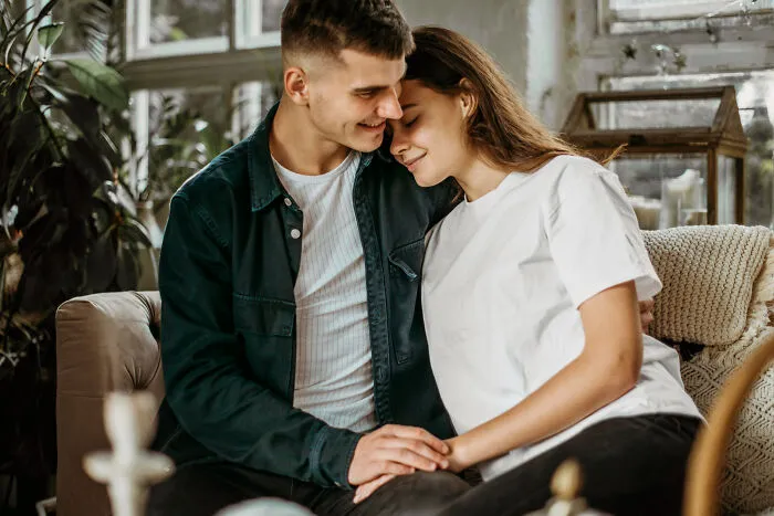 A smiling couple embracing closely, reflecting on stories of how lifelong friendships fizzled out.