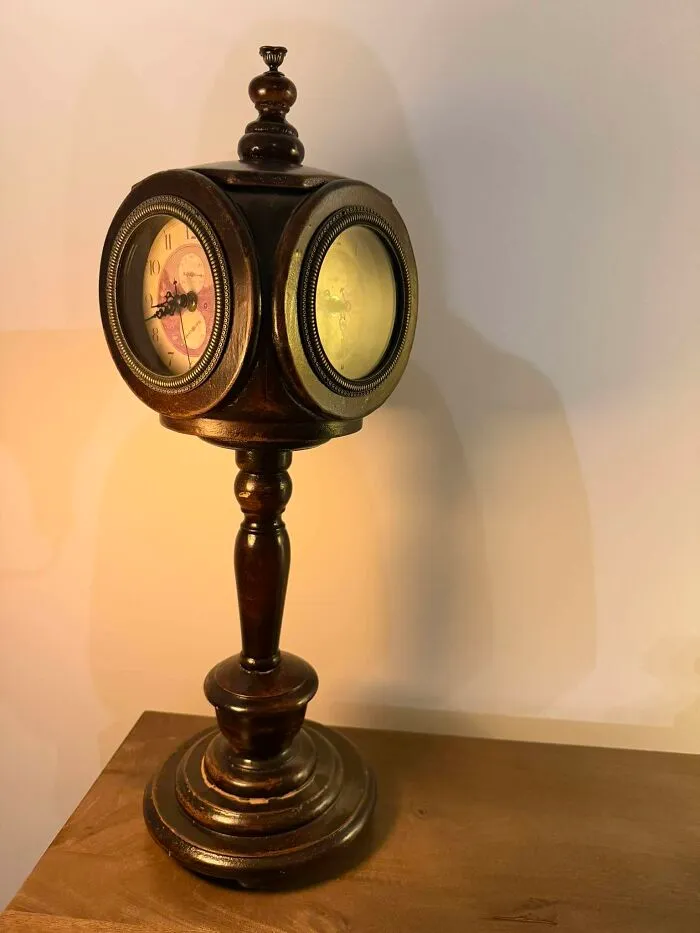 Vintage wooden clock with dual faces on pedestal base