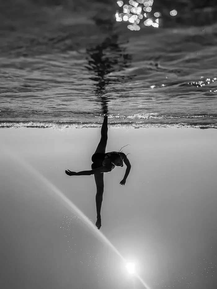 Underwater dancer silhouette with sun flare in iPhone photography