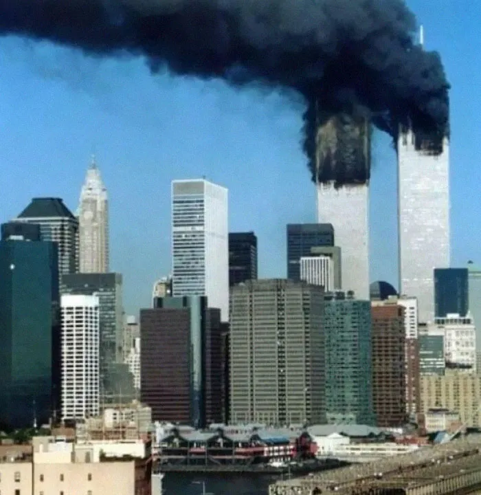 Plumes of dark smoke rising from the World Trade Center towers during the September 11, 2001 attacks