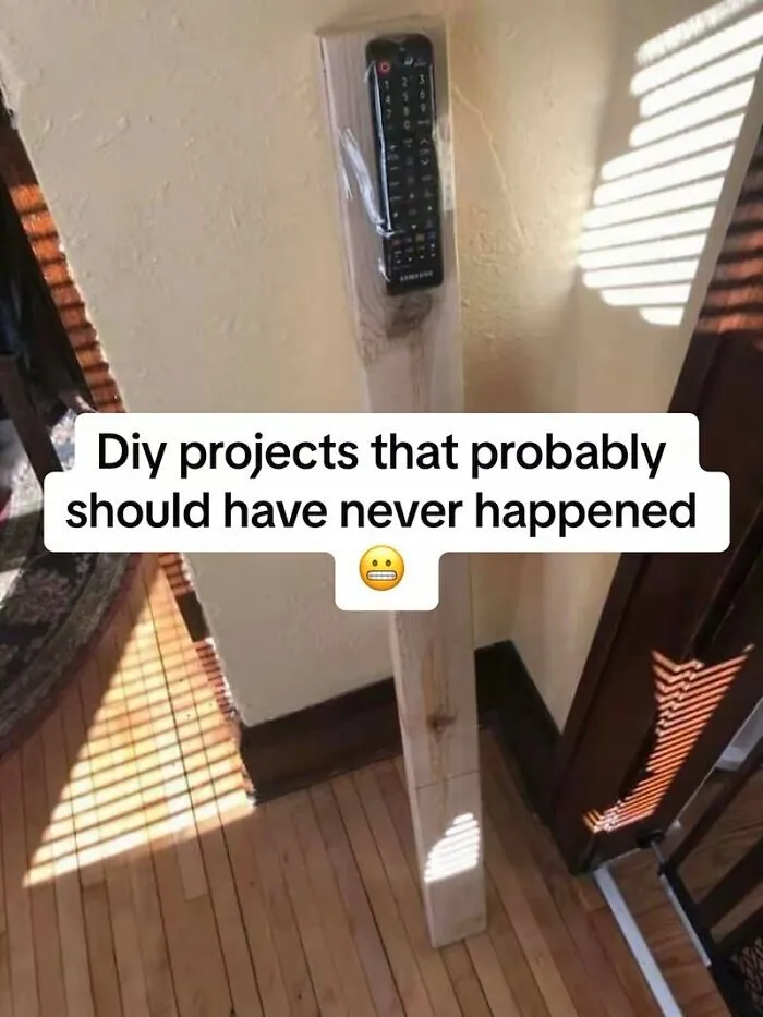 TV remote taped to a large wooden post, highlighting a DIY home improvement fiasco.