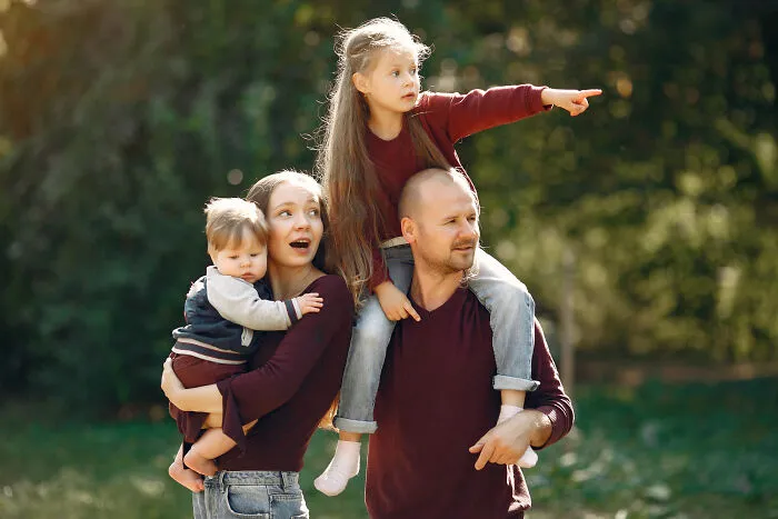A happy family of four spending quality time outdoors, reflecting on childhood and lifelong friendships.