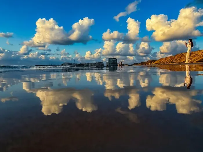 Clouds reflected on wet beach captured on iPhone photography