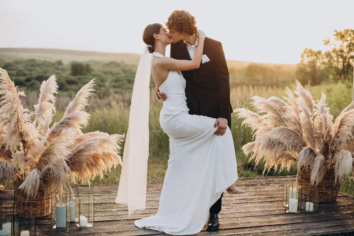 A bride and groom kiss at their wedding, a milestone where some lifelong friendships fizzle out.