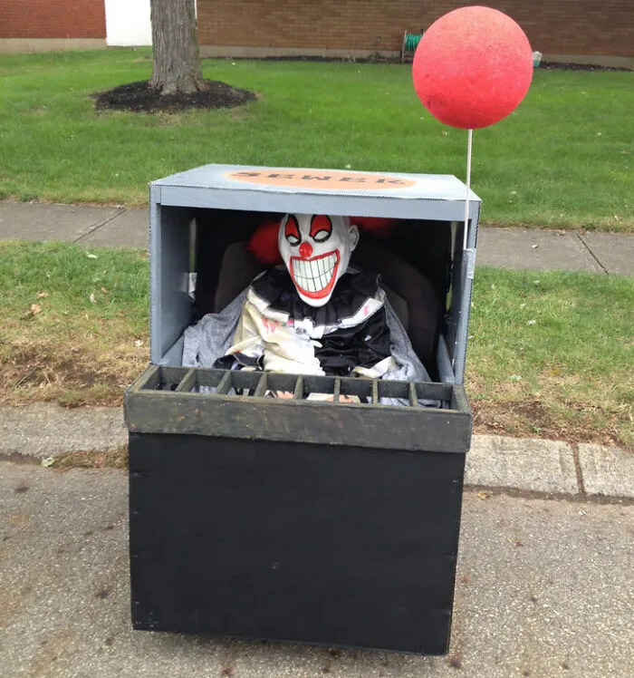 A person with disabilities in a creative Pennywise sewer grate wheelchair costume for Halloween.
