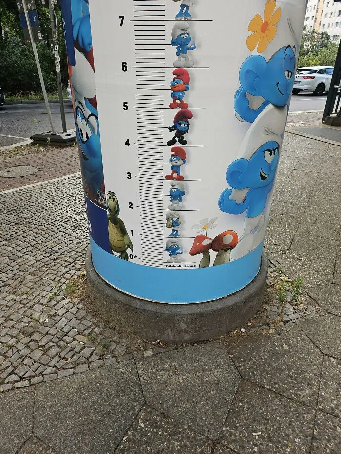 A outdoor Smurfs height measurement chart display representing advertising fails