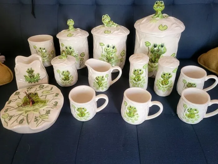 Matching frog themed ceramic kitchen set displayed as thrift finds.