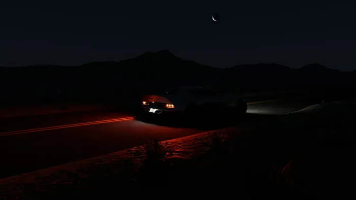 A car driving down a dark desert road at night, setting a scene for creepy Halloween stories.