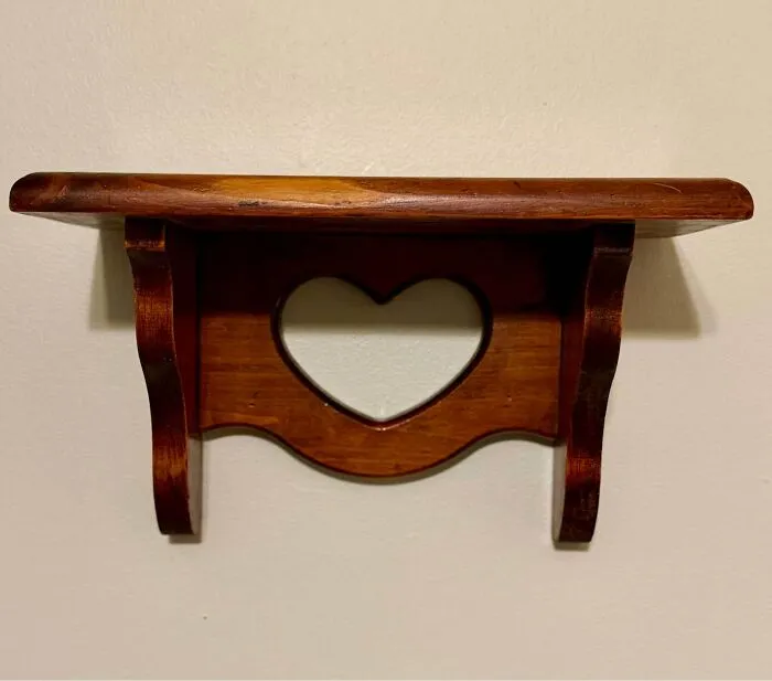 Wooden wall shelf with heart cutout thrift store decor