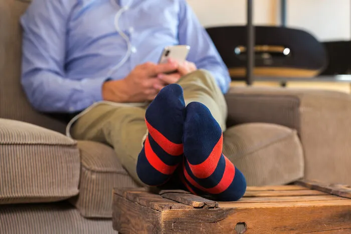 A man relaxing on a couch, illustrating real-life divorce stories about distant partners.