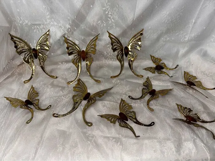 Vintage brass butterfly wall hooks thrift store finds on lace fabric