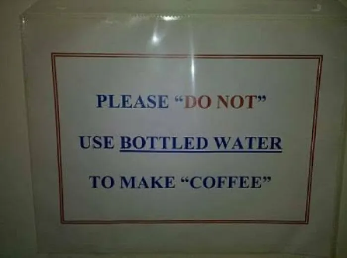 A sign with misused quotation marks reading Please DO NOT use bottled water to make COFFEE.
