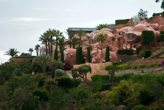 Unique strange building structures in lush greenery with round shapes and unusual design