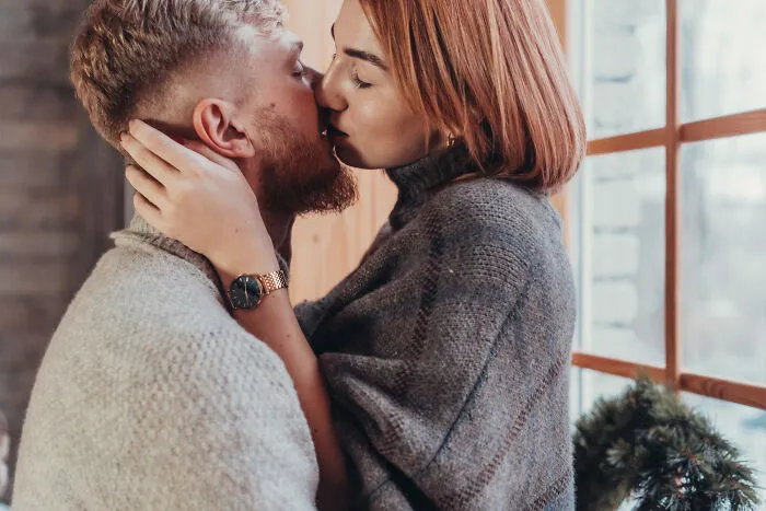 An intimate couple kissing, illustrating emotional relationship and divorce stories.