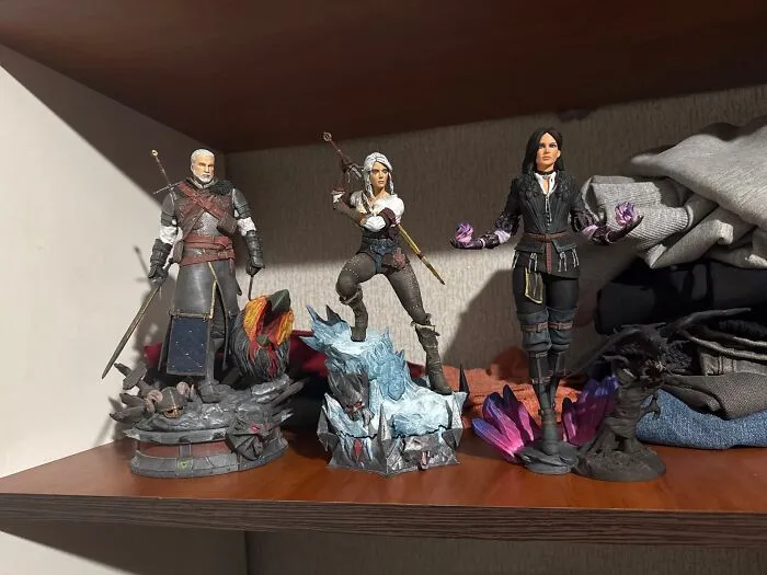 Detailed 3D prints of fantasy action figures on a shelf