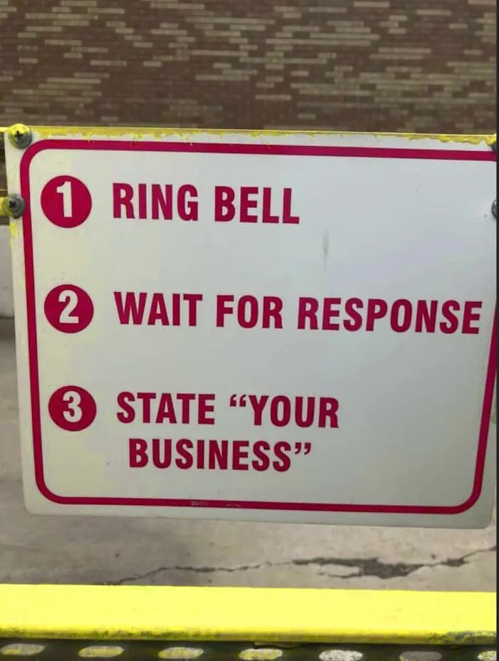 An instruction sign showing misused quotation marks around the words YOUR BUSINESS.