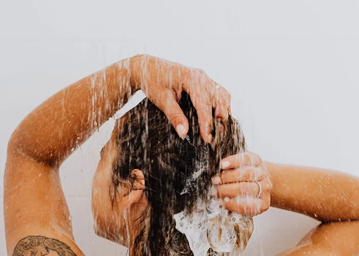 A mother taking a relaxing shower to unwind during early new motherhood