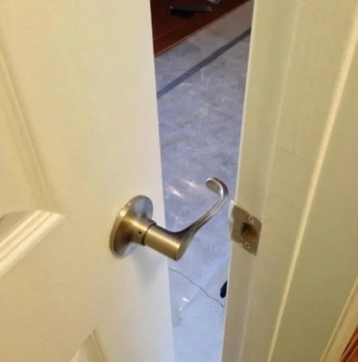 A white door where the door handle points into the door frame. Things Went Wrong Pics