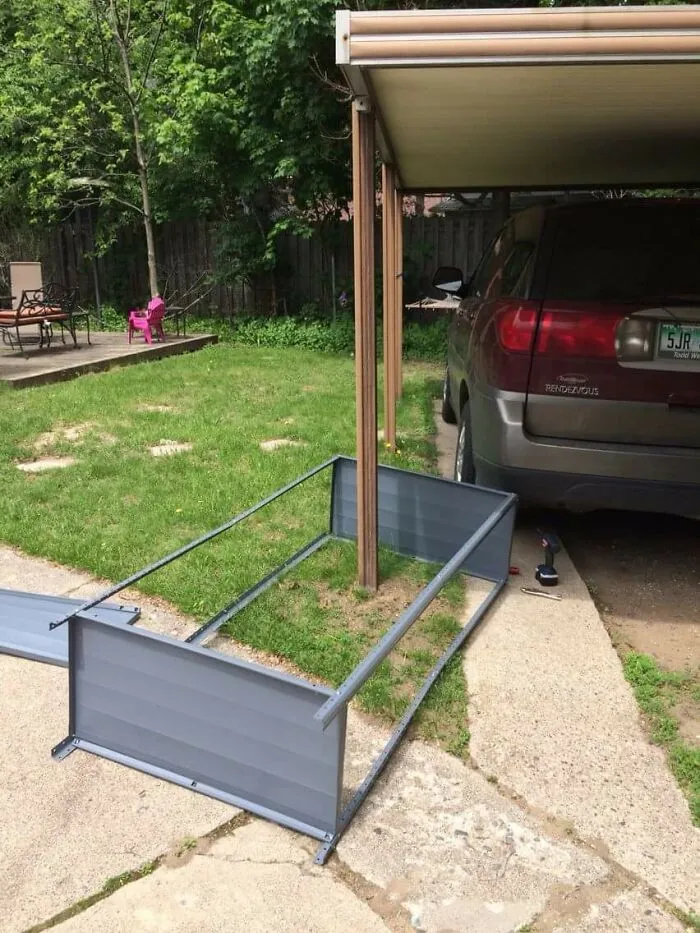 A metal frame built around a carport post in Things-Went-Wrong-Pics