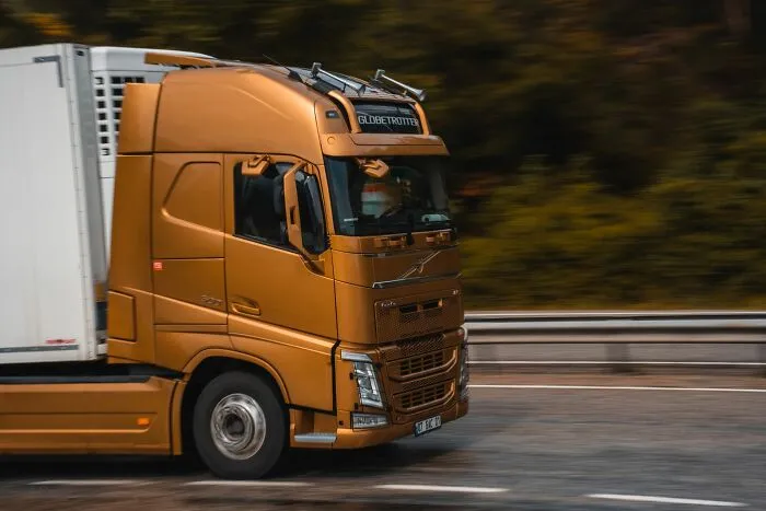 A large golden truck driving on a highway, a setting from scariest true stories.
