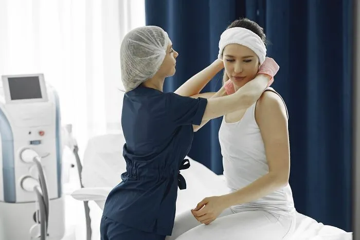 A nurse prepares a woman for a clinical procedure in a medical office, setting the scene for scariest true stories