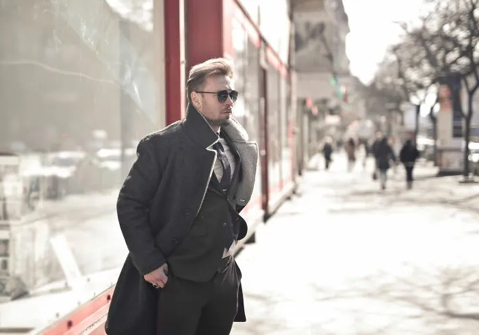 A man in a stylish winter coat, evoking the mood of scariest true stories.