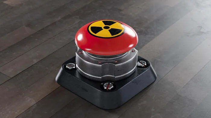 A big red button with a yellow radiation symbol, evoking scariest true stories about nuclear incidents.