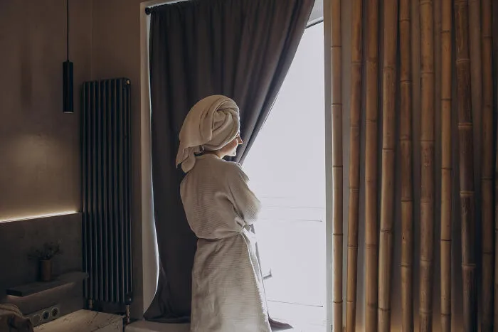 A woman in a bathrobe looking out a window, matching quick-fire jokes.