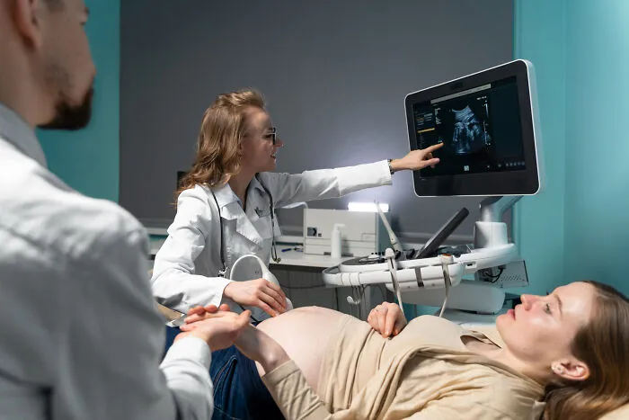 A doctor pointing at an ultrasound screen during an exam, fitting quick-fire jokes.