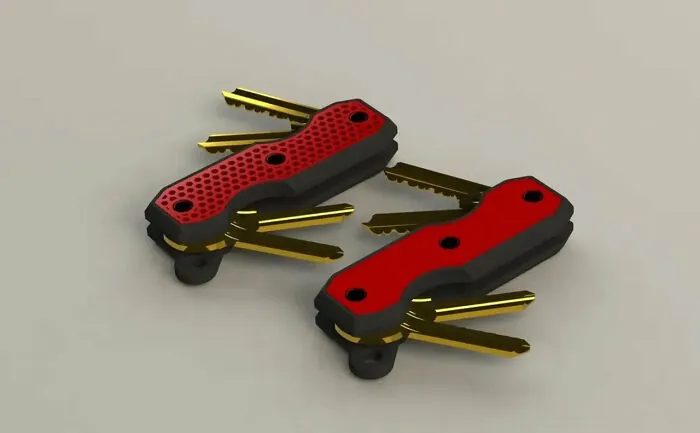 Two red and black pocket-sized key organizers made with a 3D printer.