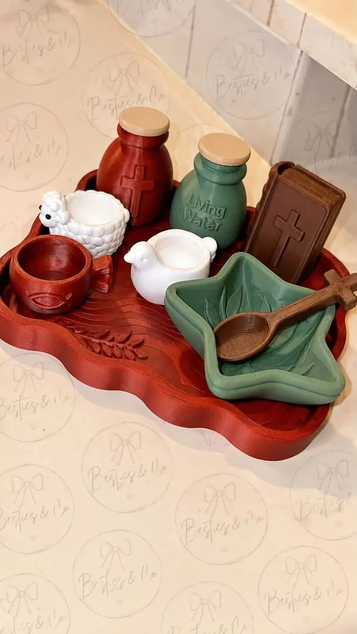 An array of 3D printed religious toys on a red tray, showing the potential of a 3D printer.