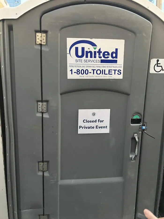 A portable toilet with a paper sign reading closed for private event among absurd signs.