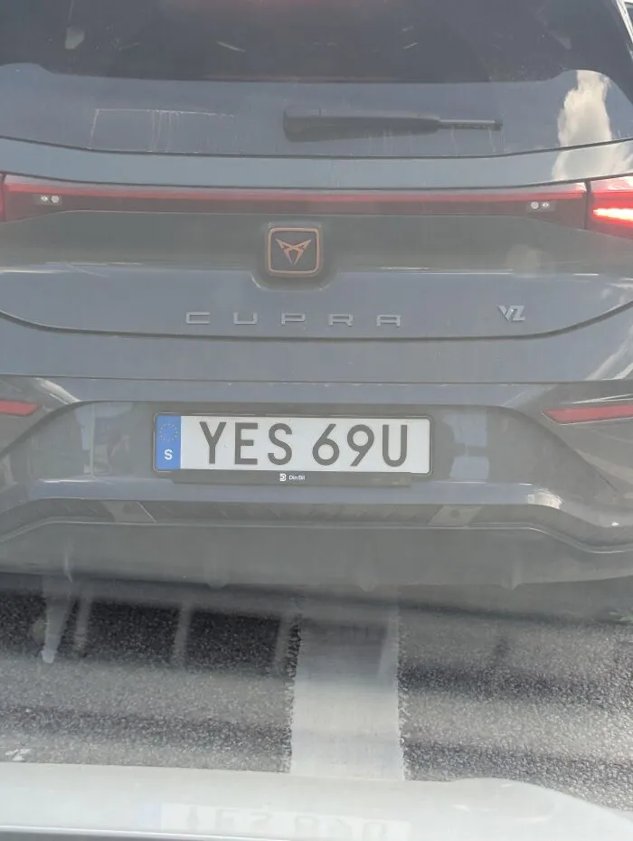 Close-up of a Cupra car rear featuring an absurd license plate reading YES 69U.