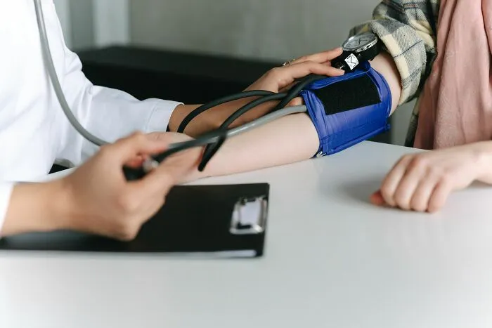 Doctor measuring blood pressure on patient's arm