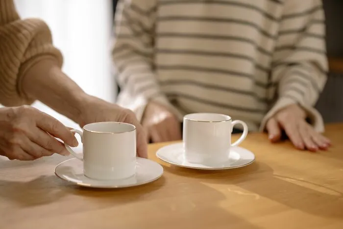 Two people having tea representing conversations about weight-related comments