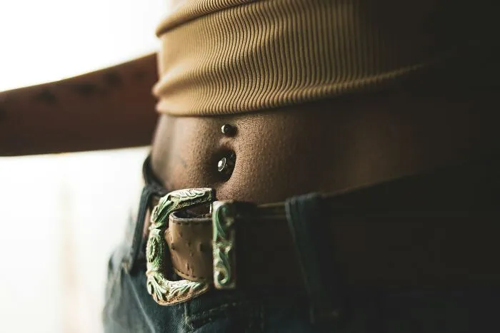 Close-up of waist with belt and belly showing skin texture