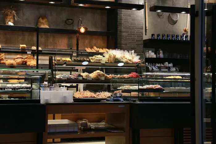 Bakery display full of breads and pastries with warm lighting
