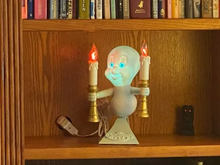 Glowing Casper the Friendly Ghost lamp placed on a shelf, a cool thrift find