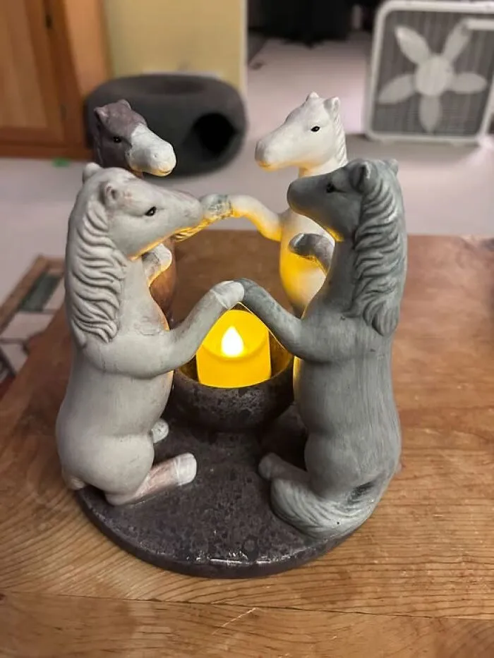 Four horse figurines forming a circle around a candle, a weird thrift find