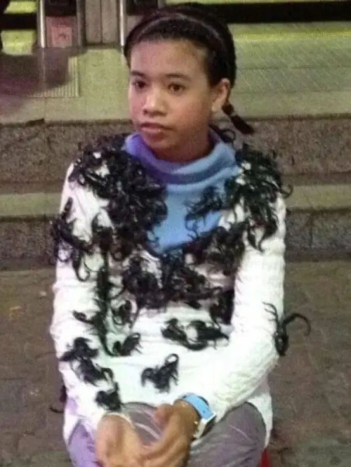 A girl covered in live scorpions as part of cursed images.