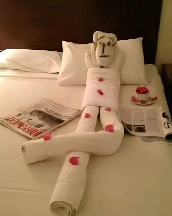 A creative towel figure relaxing on a bed, one of many fun photos.