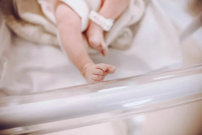 Close up of a newborn baby's feet in a hospital highlighting human body facts