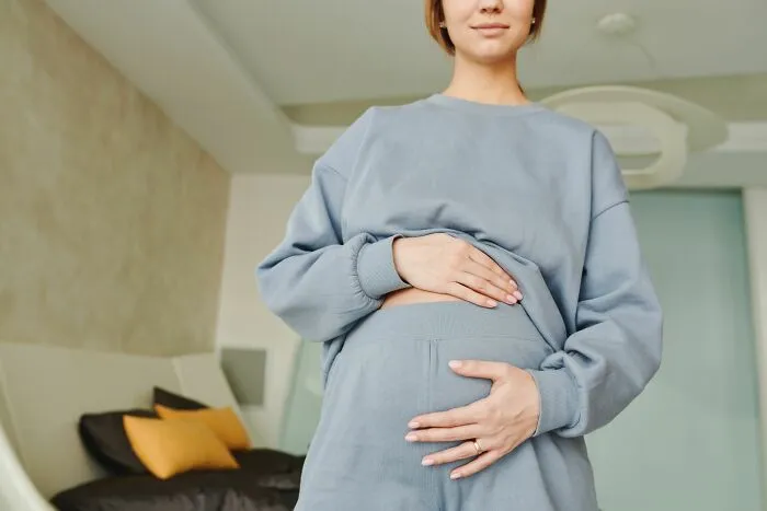 A pregnant woman holding her belly showing human body facts