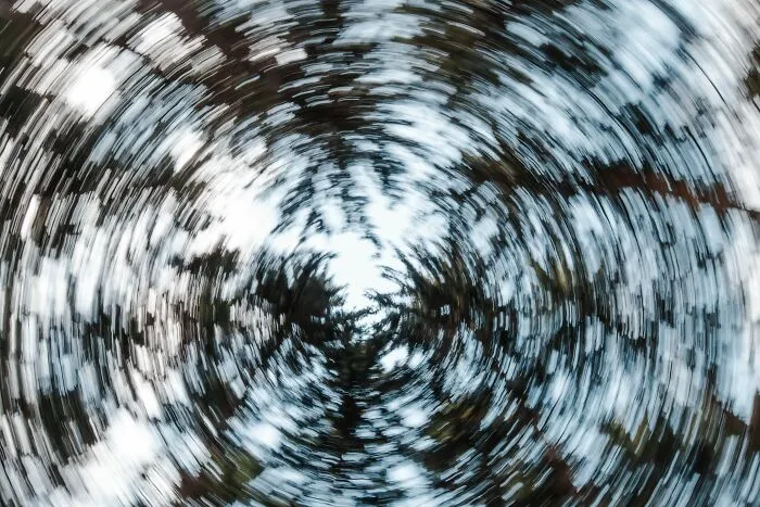 Swirling abstract view looking up into tree canopy illustrating human body facts and brain perception.
