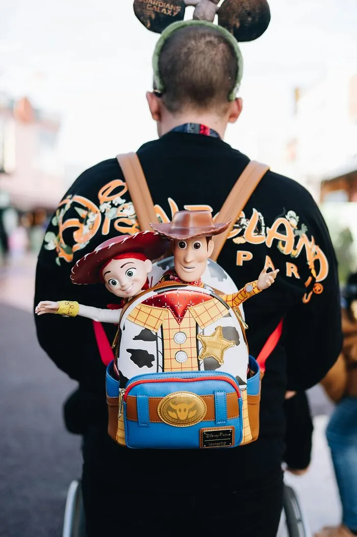 A person wearing a Toy Story backpack, showing weird behavior at work
